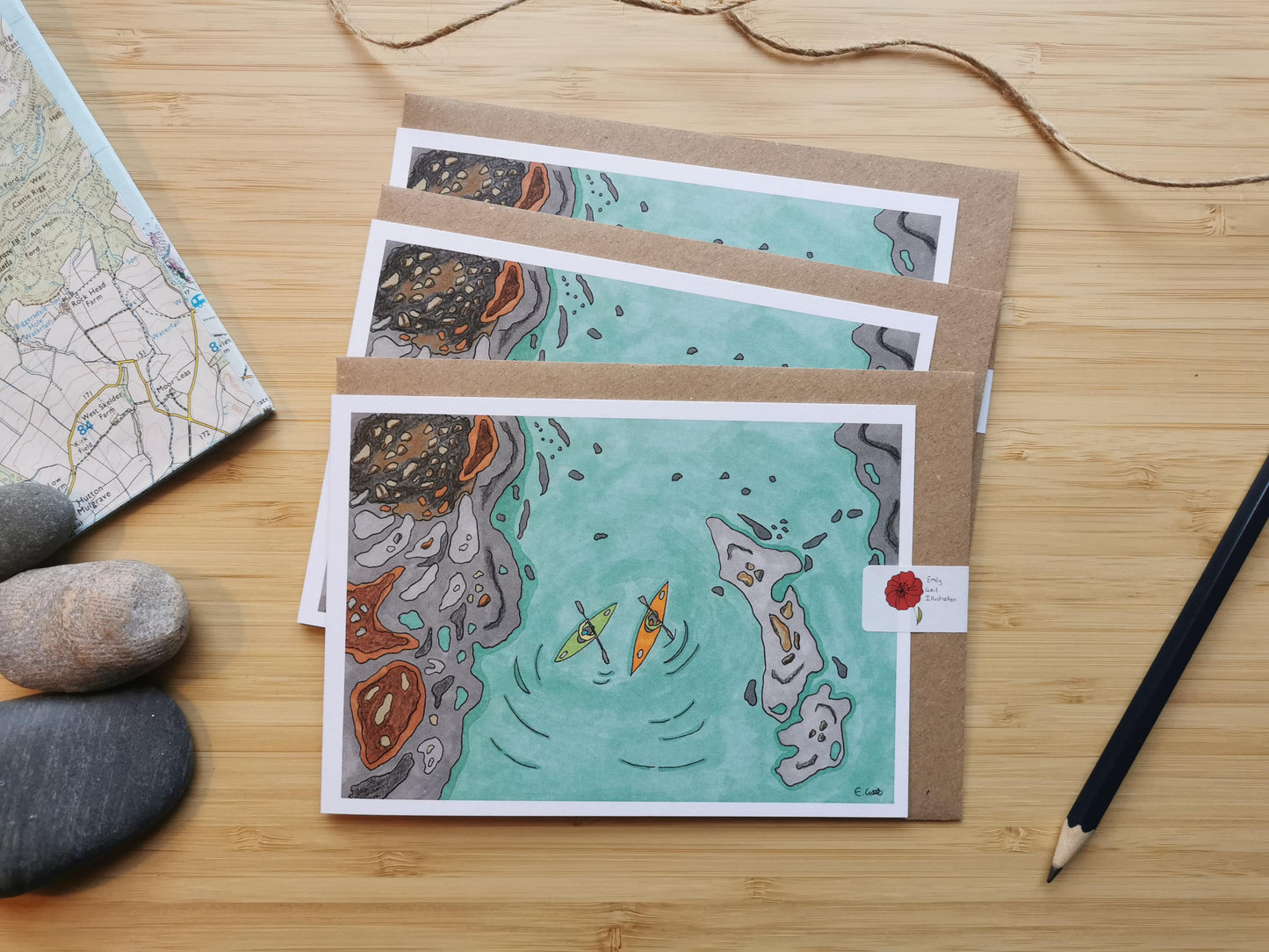 Set of 3 cards of an illustration of two kayaks paddling around some rocky islands.