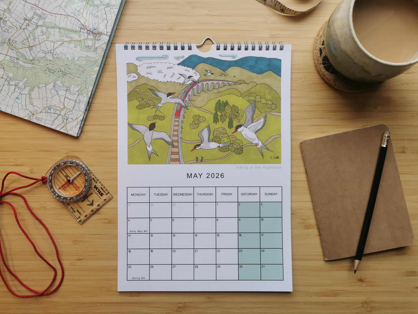 Calendar closeup of the month of May. Illustration of birds following a steam train into the highlands.