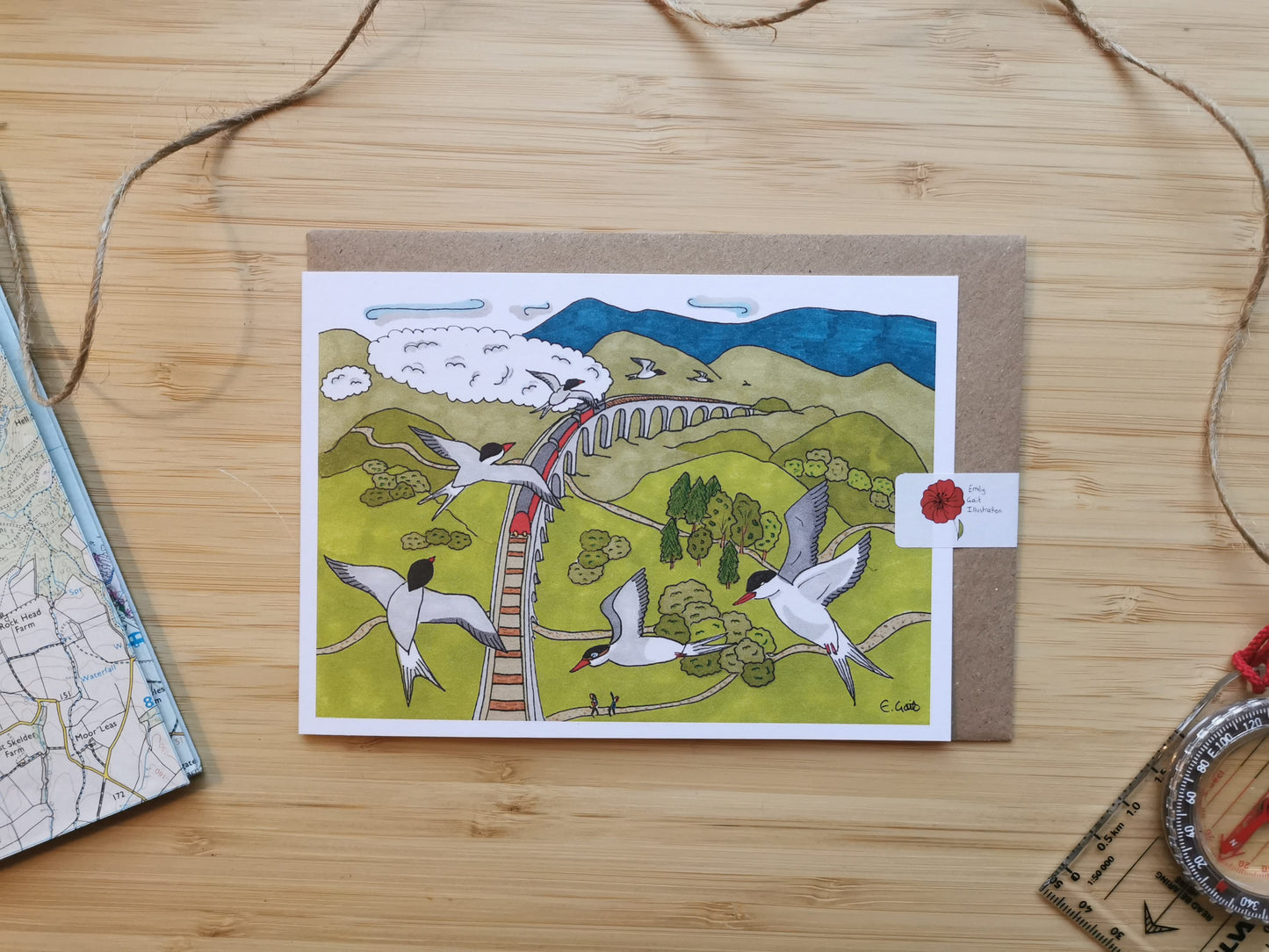 Greeting card with an illustration of Arctic terns flying over a viaduct with a steam train going over, in the highlands in Scotland.