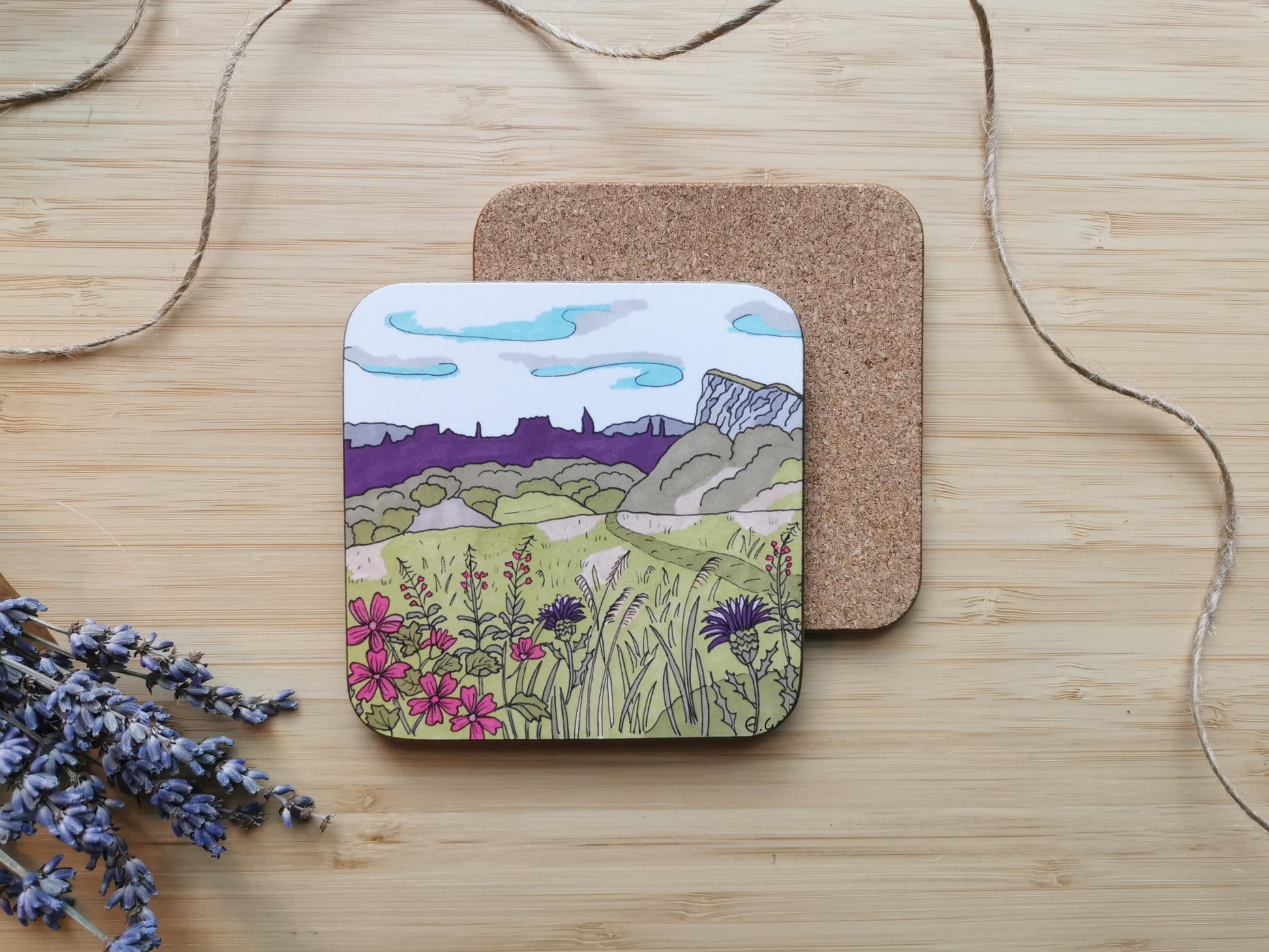 Coaster with an illustration of Salisbury Crags, Arthur's Seat in Edinburgh with the skyline of the city and rosebay willowherbs in the foreground.