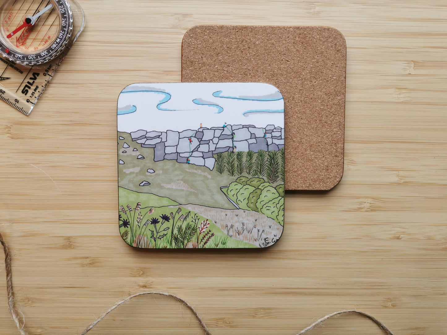 Coaster with landscape design of climbers on Stanage edge in the Peak District, with thistles and grasses in the foreground.