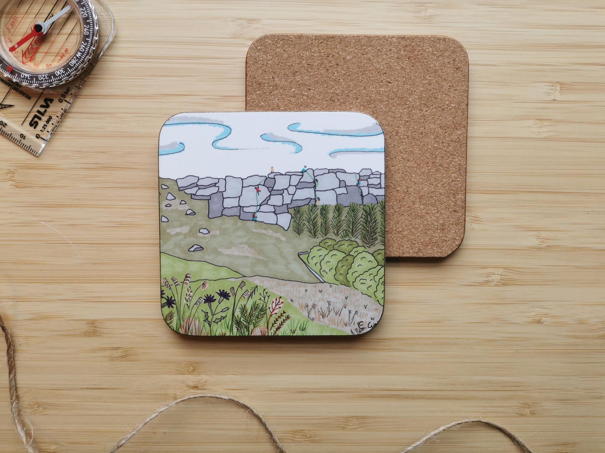 Coaster with landscape design of climbers on Stanage edge in the Peak District, with thistles and grasses in the foreground.