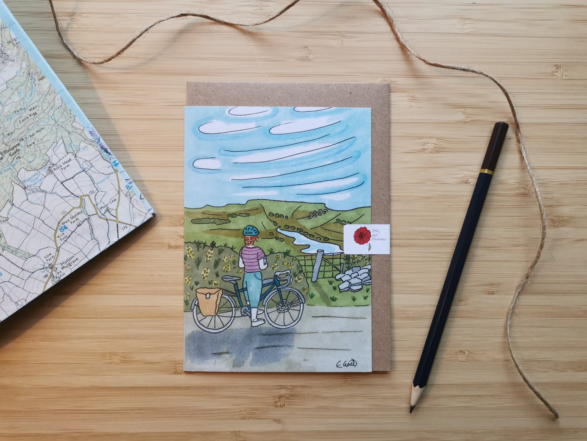 Illustration of a lady and a bike looking over the top of a hill with hills and a reservoir in the distance.