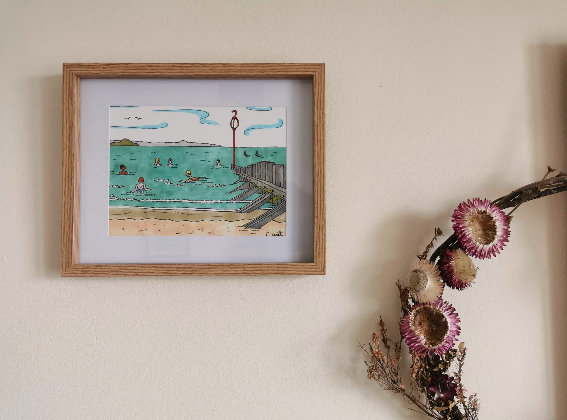 Wooden framed picture of an illustration of people swimming in the sea at Portobello Beach in Edinburgh.